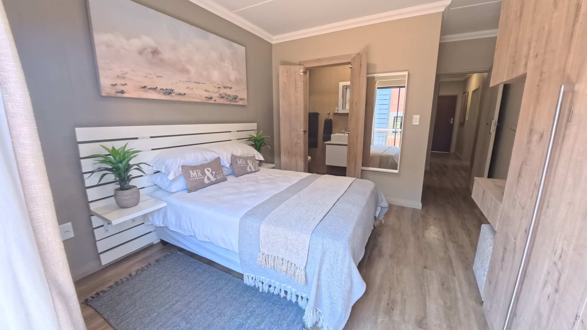 Comfortable main bedroom with natural lighting