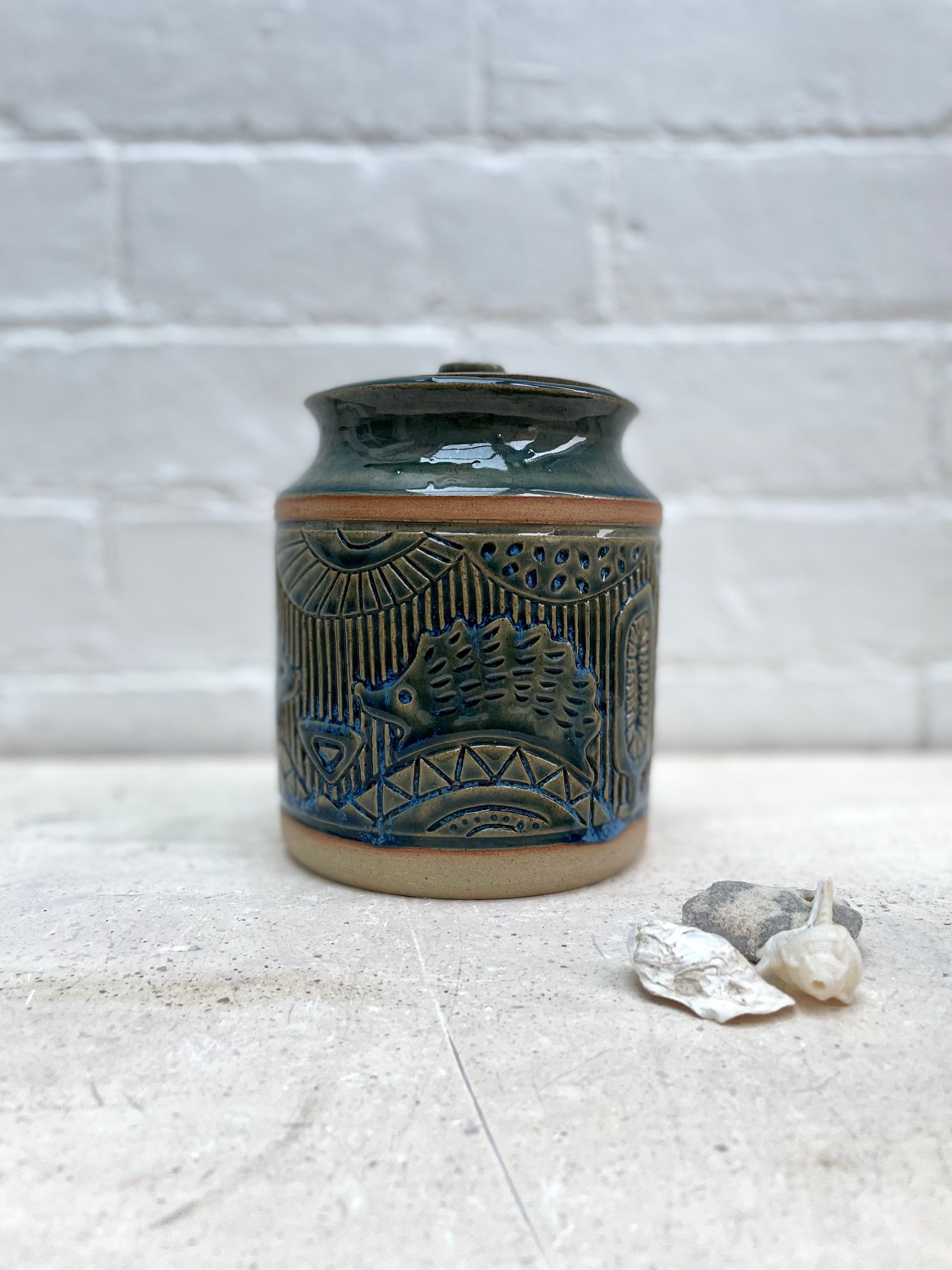 Storage Jar with carved woodland animal and fruit designs