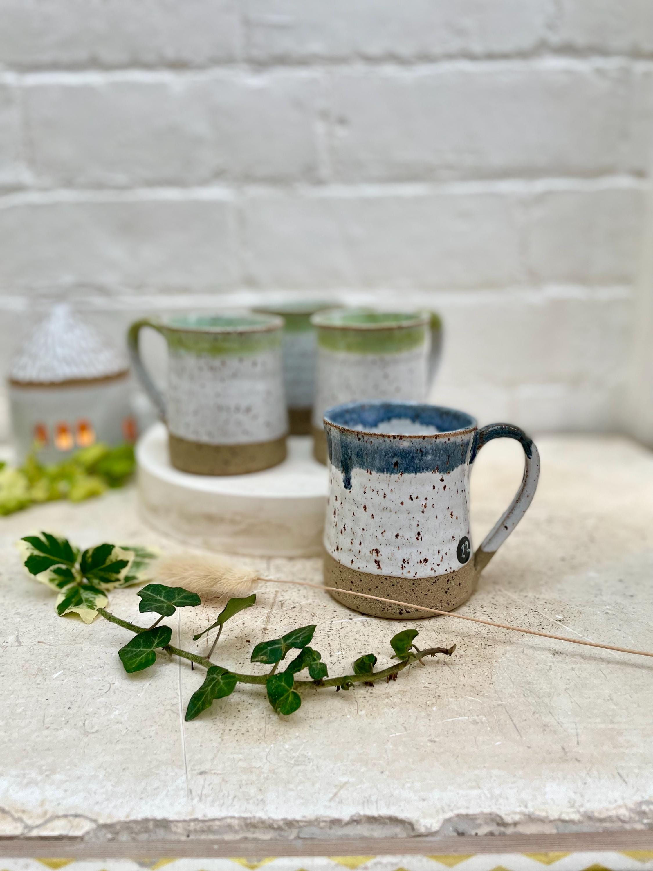 200ml mugs, textured stoneware, in white with coloured rims.