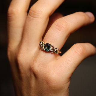 Women's wedding ring from red, yellow and white gold with oval Tourmaline size 8 x 6 mm, and Sapphires, Tourmaline and cognac diamond at sides.