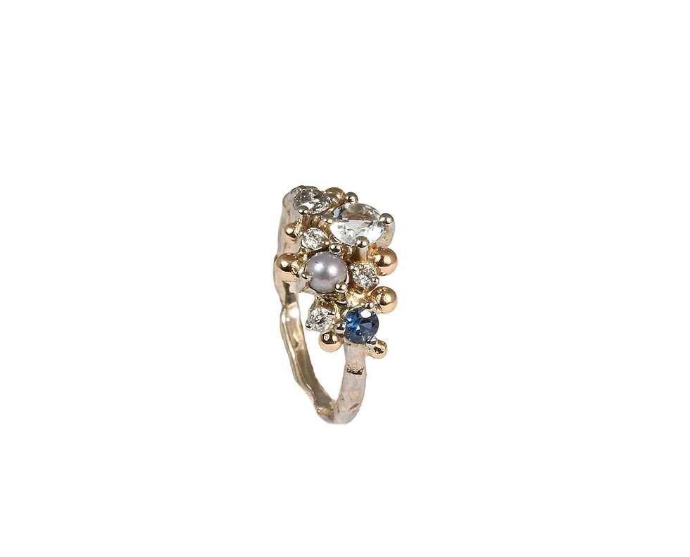 Thumbnail: Artistic gold ring with various gemstones