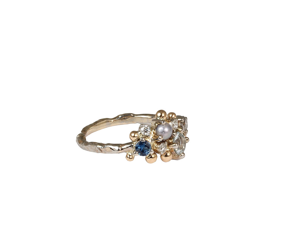 Thumbnail: Artistic gold ring with various gemstones