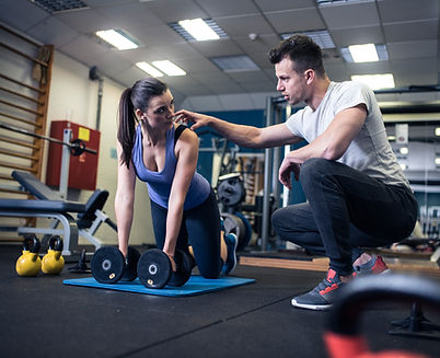 Personal trainer begeleidt klant bij training in een praktijk