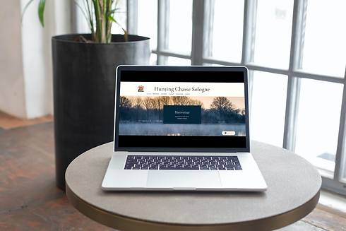 MacBook Pro on the round light wooden table_Site hunting.png