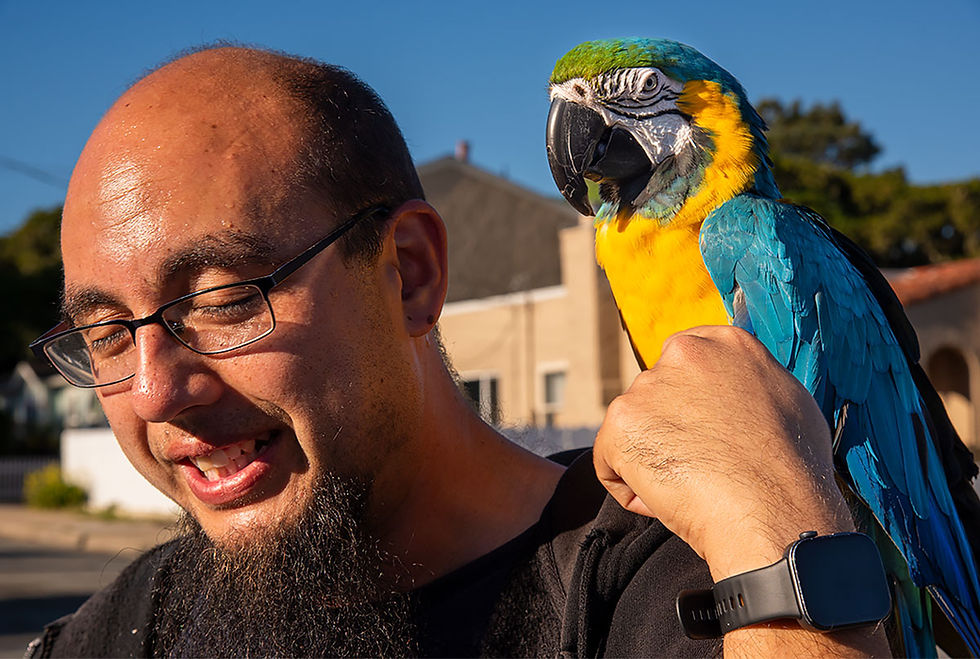man holding a blue and gold macaw, Tracks by the Post 2026 no.9 springtime blooms, www.egrettracks.com, www.fbphoto.com