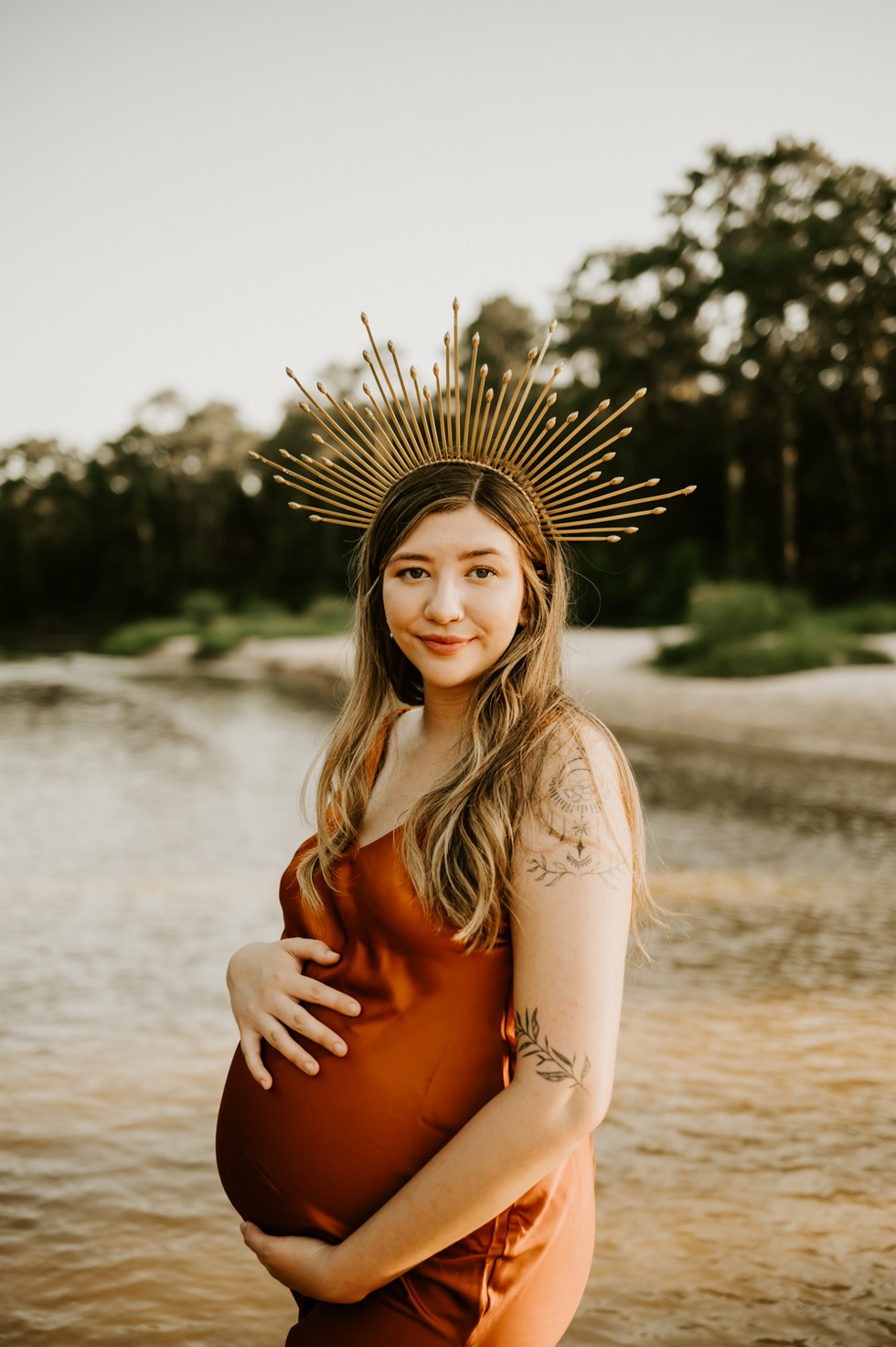 A pregnant woman in a gold dress