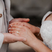 Braut und Bräutigam halten sich an den Händen