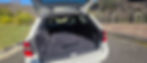 Spacious open trunk of a white station wagon