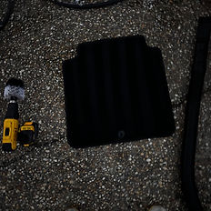 Black car floor mat sitting on concrete with tools and Showroom Special