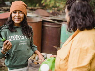A teenager daughter and mother gardening