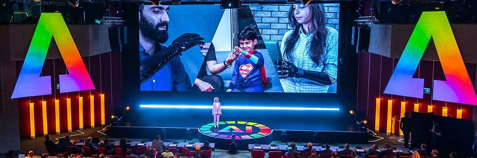 Conference stage with a speaker, giant rainbow A logos, and a screen showing people. he AI for Good Global Summit 2026 gathered participants from over 170 countries in Geneva, reaffirming its role as the United Nations’ premier platform for shaping the future of AI.