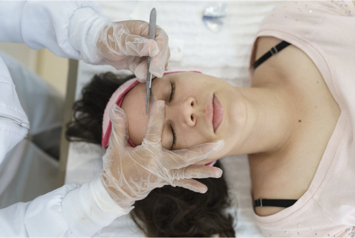 girl getting dermaplaning facial rejuvenation treatment from medical spa
