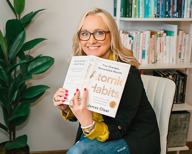 Amanda Kemmel reading the book "Atomic Habits"