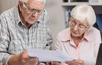 older adult asking for help looking at documents from other older adult.jpg