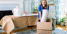 Woman professionally packing a moving box helping homeowners with a move