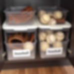 bins labeled with baseball equipment to organize