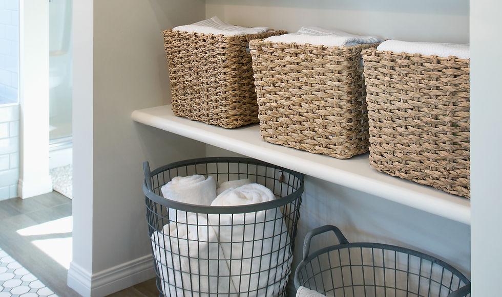 Professional Home Organizer that organized the bathroom with baskets for laundry and towels - Acton, MA - The Lighter Home