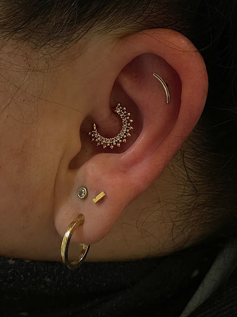 Close-up of a stylish body piercing with fine 14 karat gold jewelry at Pierce Your Soul studio in Glendale, CA.