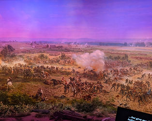 A detail of the Cyclorama mural depicting heavy cannon fire, billowing white smoke, and artillery units in the heat of battle.
