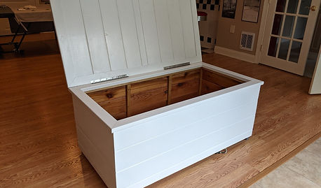 Cedar outdoor storage cabinet painted white with its lid open.