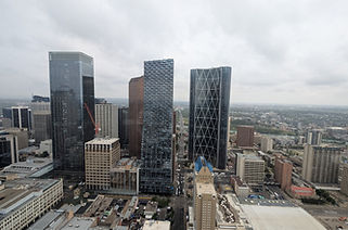 Calgary Tower is surrounded by taller modern buildings with scenic views