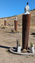 Pou Whenhua statues on poles near Castle Hill