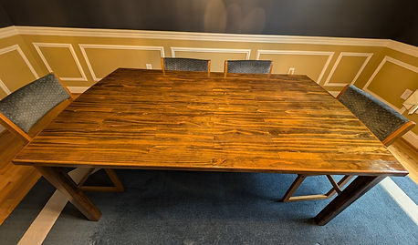 Side view of a dining room table made from many small poplar boards.
