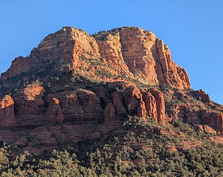 The distinct bell-shaped red rock formation of Bell Rock under a clear blue sky.