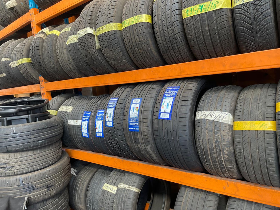 New and part-worn tyres on orange shelving at Lomond Car Wash & Tyres in Coventry.