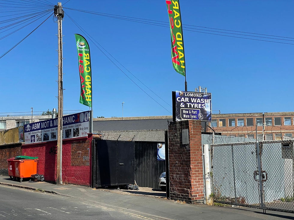 Entrance to Lomond Car Wash & Tyres at 7 Brays Lane, Coventry, with the Lomond sign and car-wash flags.