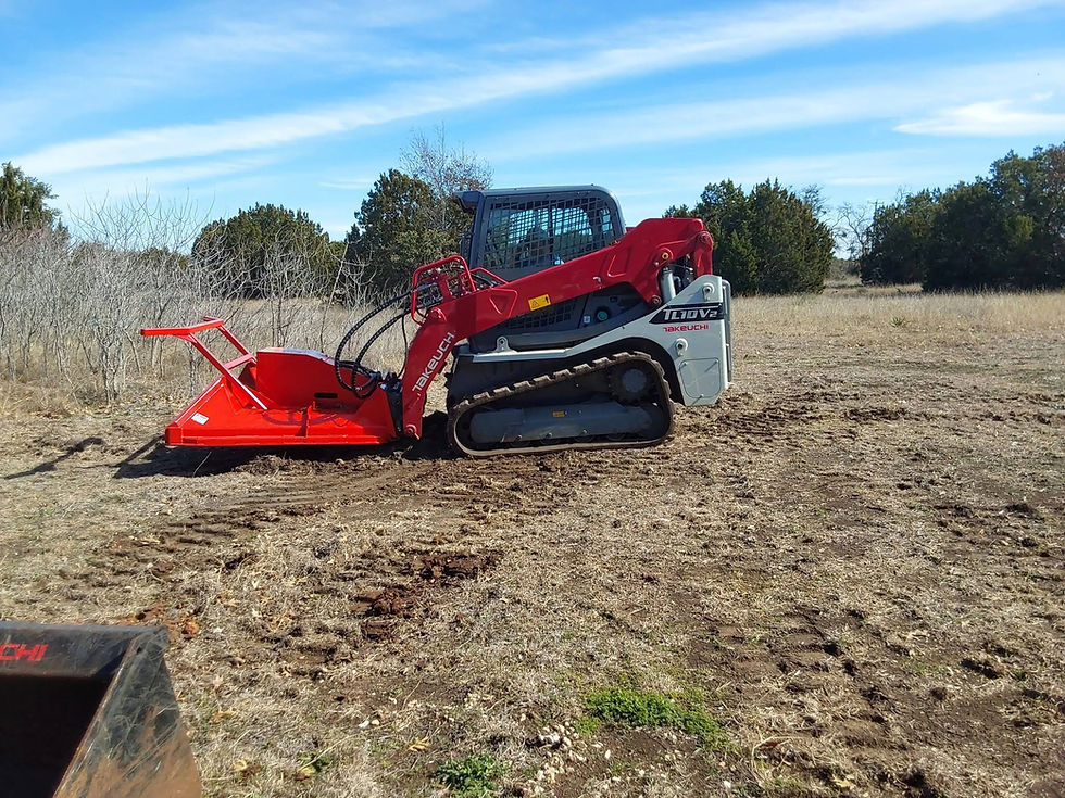 Compact track loader with red grading attachment on a field