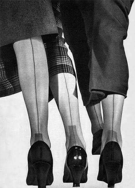 Women wearing seamed retro stockings and classic shoes in a vintage black-and-white photograph illustrating authentic 1940s and 1950s hosiery fashion.