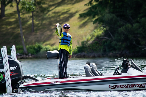 Student angler holding a bass