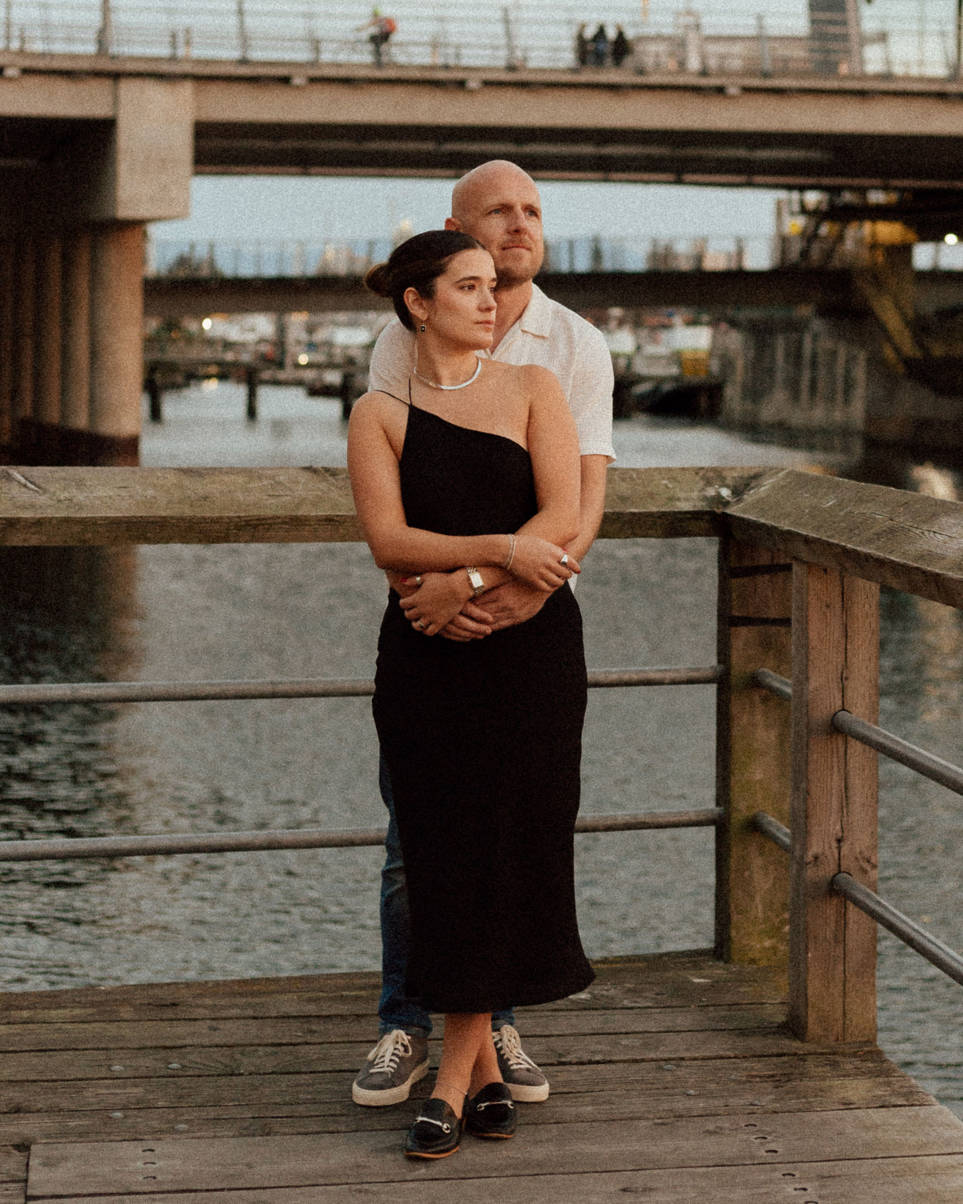 Fiona and Kevin during their Downtown Victoria engagement session with brick walls and sunset waterfront views