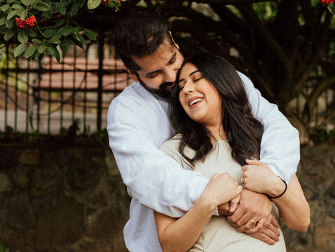 Maternity photo session at the Empress Hotel in Victoria BC featuring a couple celebrating their pregnancy with warm, natural portraits around the historic building and gardens.