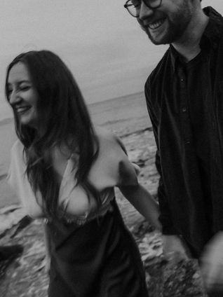 Michayla and Max coastal engagement at Island View Beach in Victoria BC, walking and laughing, joyful couple in love