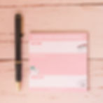 Pink Hygienist notes notepad front view next to a pen.