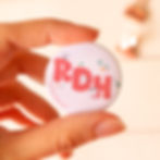 Hand holding a dental pin that says RDH