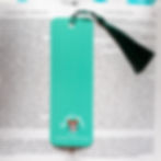 Thumbnail: Close-up view of back of green bookmark with tassel