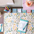 Flat lay of a desk with colorful dental stationery.