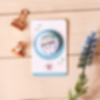 Flat lay of whimsical button pin featuring a tooth with toothpaste hair and a toothbrush brushing it
