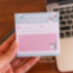 Hand holding a blue and pink dental appointment reminder