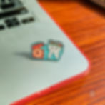 Thumbnail: Close-up view of a dental enamel pin on a laptop