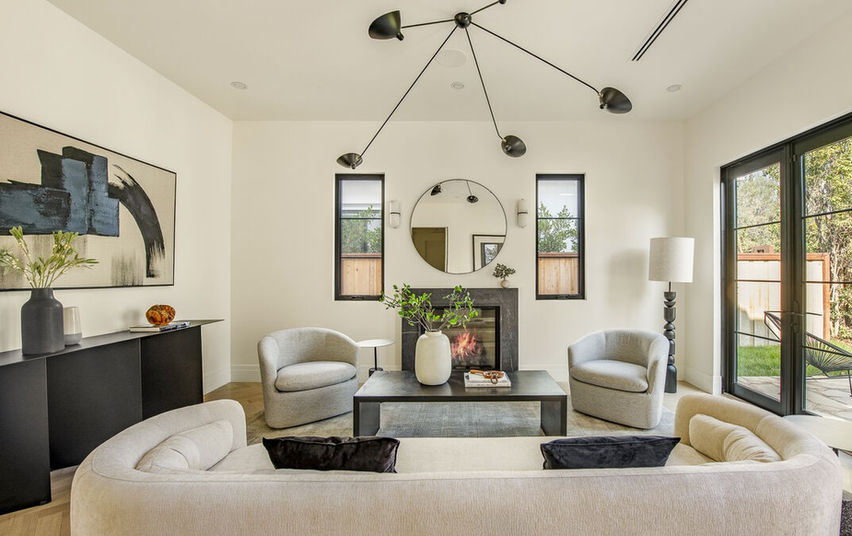 Living room with sectional sofa, fireplace, and staircase, Brentwood residence