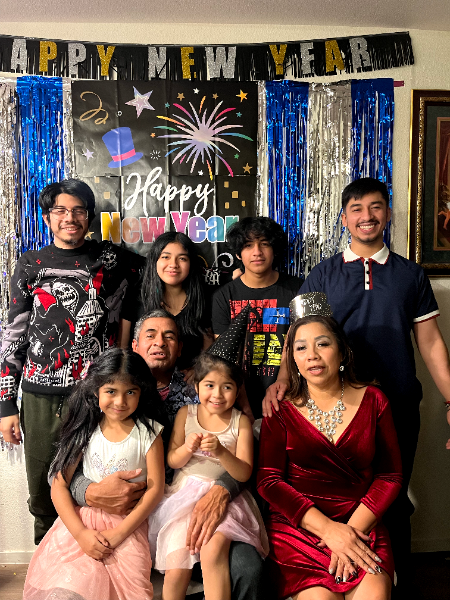 Flor and her husband Angel with their seven children on New Year's Eve.