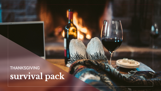 Thanksgiving survival guide post with cozy socks, wine, and a fire for Fall or winter