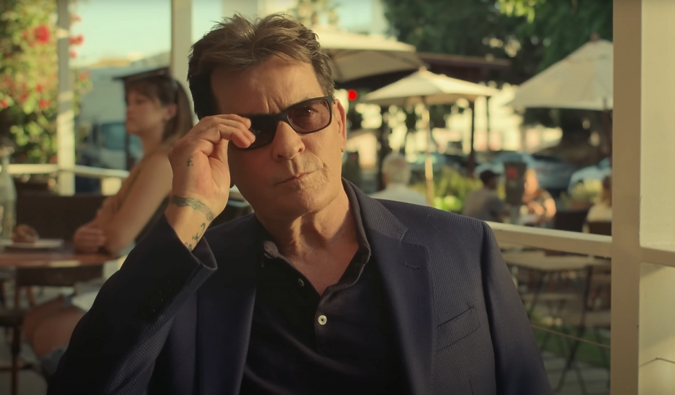 Charlie Sheen taking off his glasses