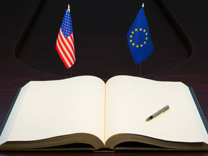 Flags of the United States and the European Union with an open book in the foreground, suggesting the future of transatlantic relations are still to be written
