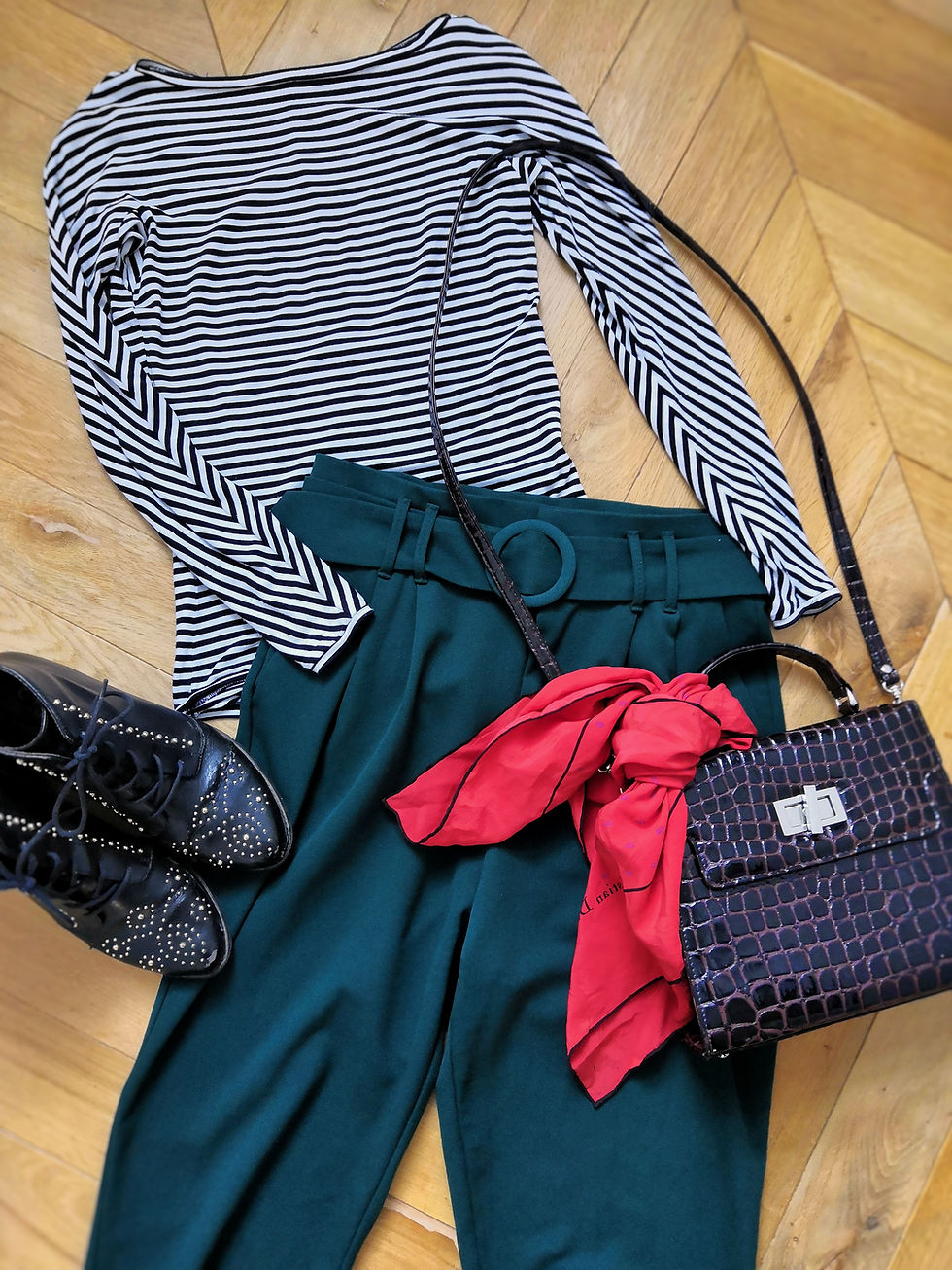 Flatlay outfit with stripy bodysuit, trousers, bag, scarf and boots