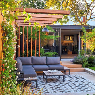 Pergola terrace with moroccan tiled rug centrepiece